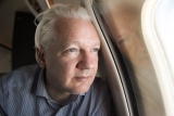 Julian Assange on board the aircraft that took him from the UK to Saipan.